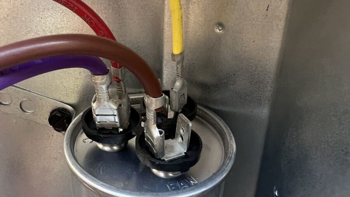 Dual run capacitor replacement on a Sacramento AC condenser — the part that fails when the outdoor unit hums and the fan never starts.