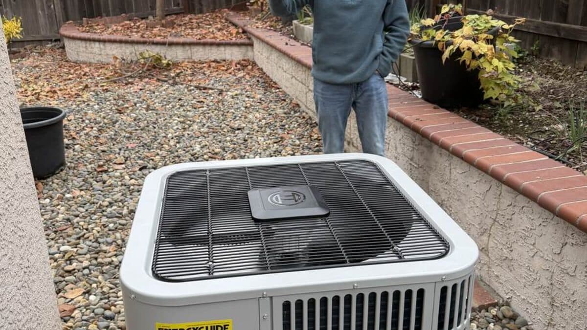 Outdoor heat pump condenser in a Sacramento yard — the unit that ices over or sticks in cooling when the house wants heat.